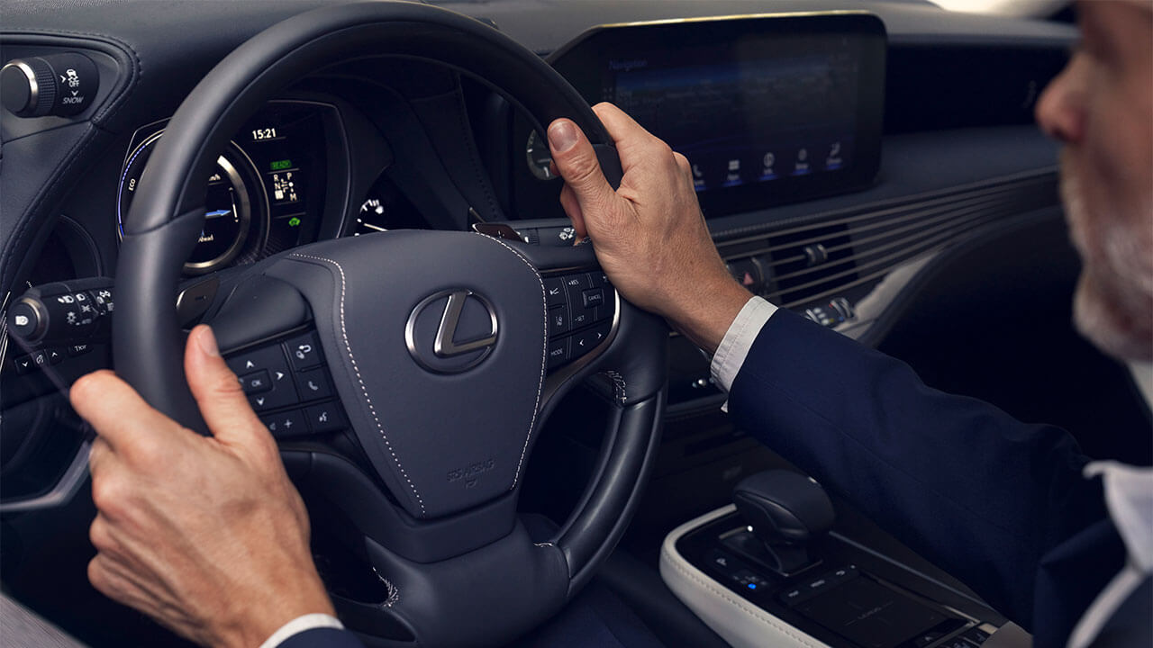A man holding the Lexus LS steering wheel 