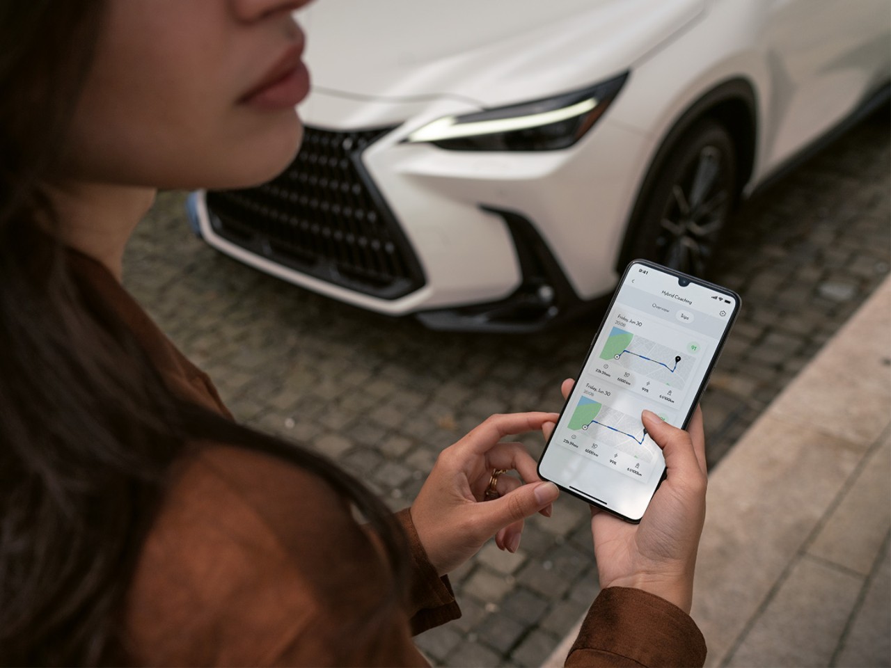 A person using a mobile phone to access the Lexus Link+ app